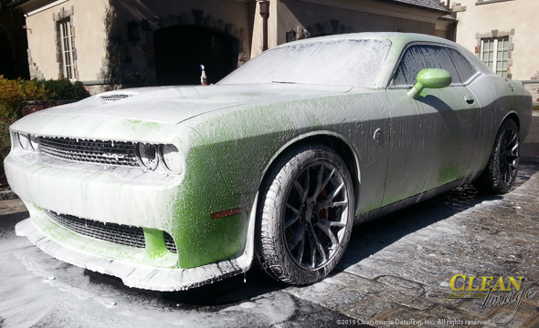 Lime green Dodge Challenger in foam bath.