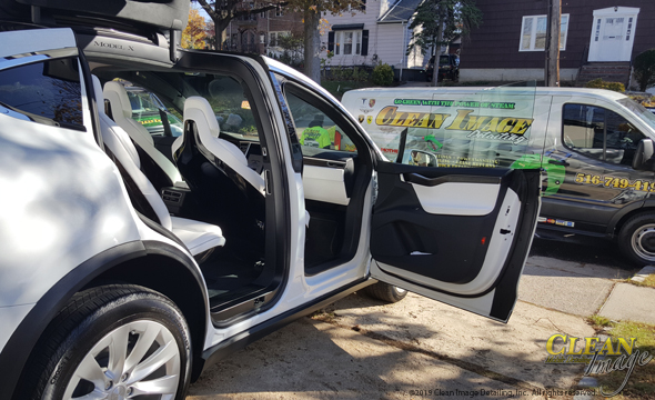 White and black Tesla with freshly detailed interior.