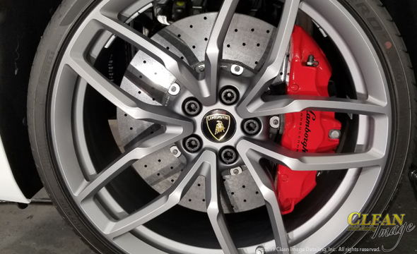 Polished Lamborghini rim and Lamborghini brake caliper.